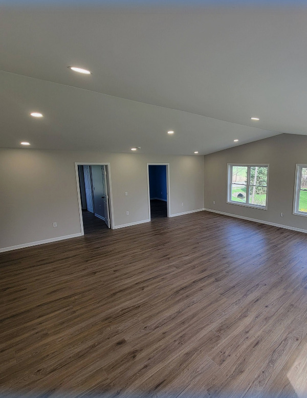 Open-concept finished interior with hardwood floors