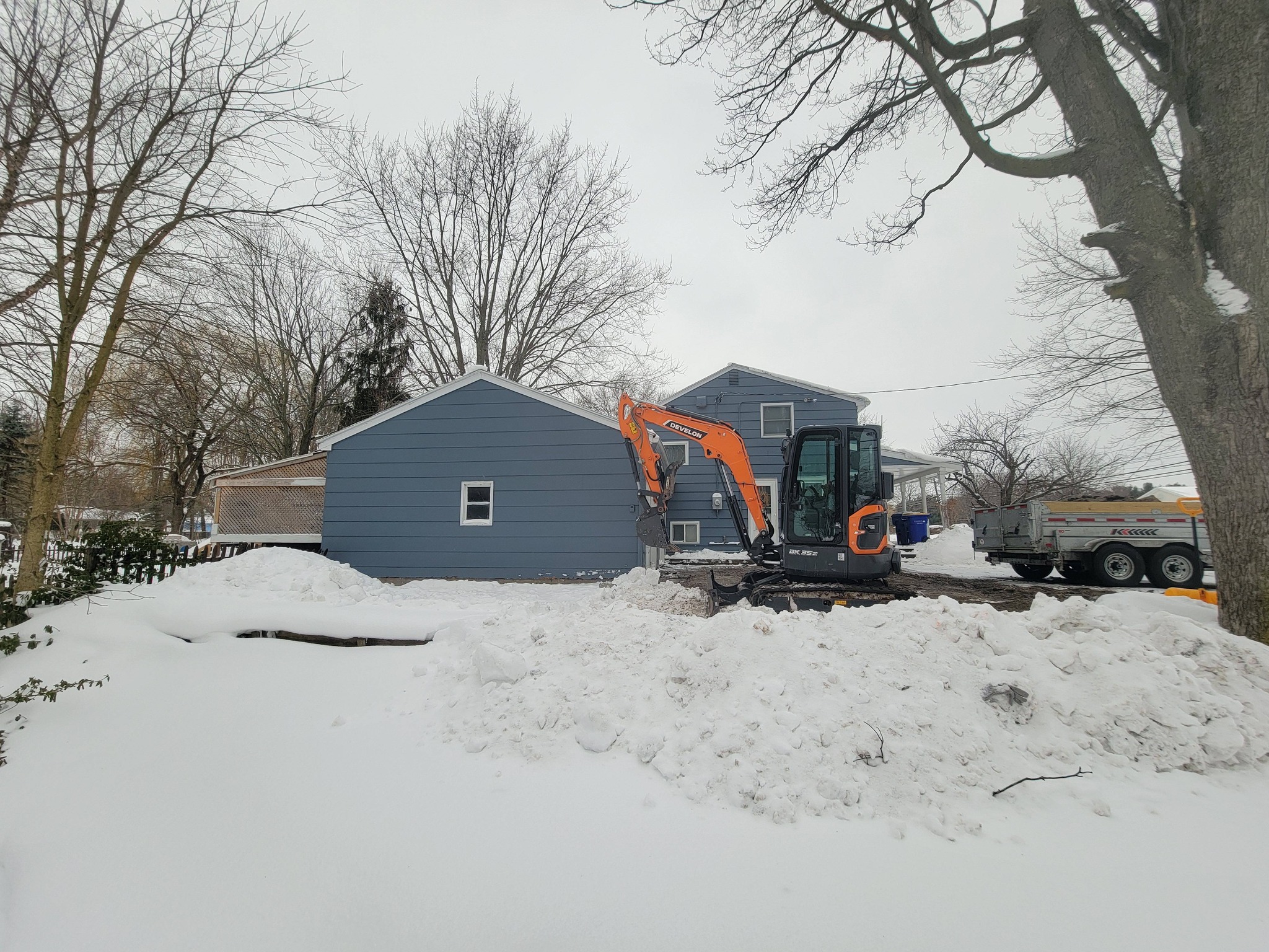 Mini excavator on site digging in winter conditions